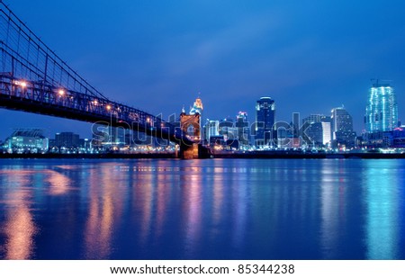 A view of Cincinnati, Ohio?s skyline cityscape overlooking the Ohio River at night.