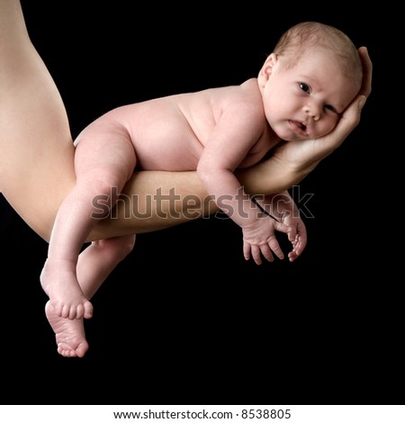 Four weeks old baby on a arm. Studio picture