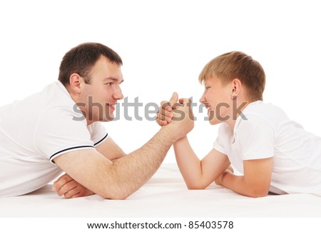 Father and son in arm-wrestling competition isolated over white background