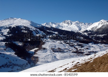 panorama of snowy mountains in the sunny swiss alps around christmas time