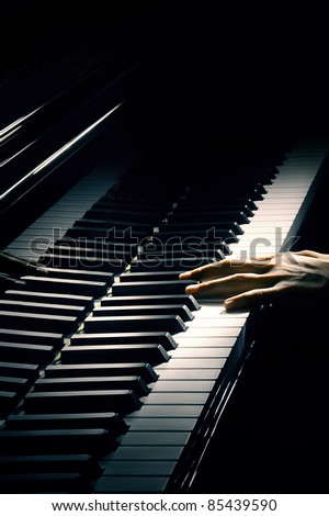 Piano music pianist hand playing. Musical instrument grand piano details with performer hands on black background