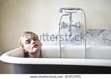 Beautiful woman lying in a bathtub
