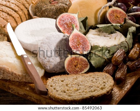 slice bread with an assortment of cheeses and fruits