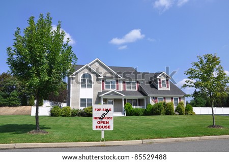 Real Estate For Sale Sold Sign on Front Yard of Luxury Suburban Home Neat Landscape