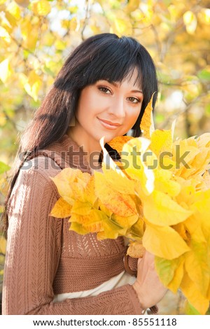 Young pretty woman in the autumn park