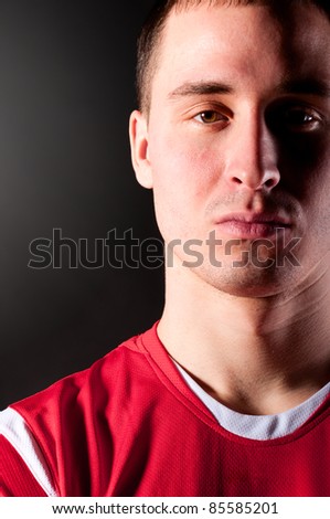 close-up of soccer player on dark background