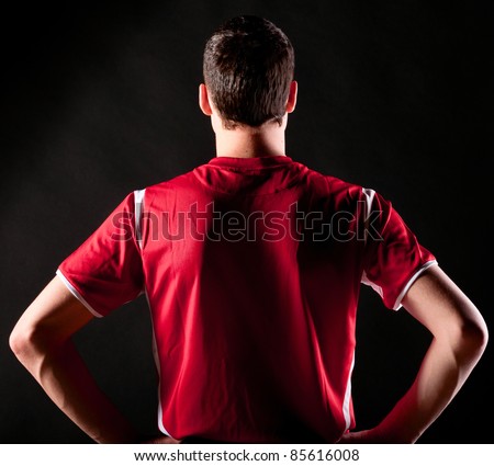 back of soccer player on black background Royalty-Free Stock Photo #85616008