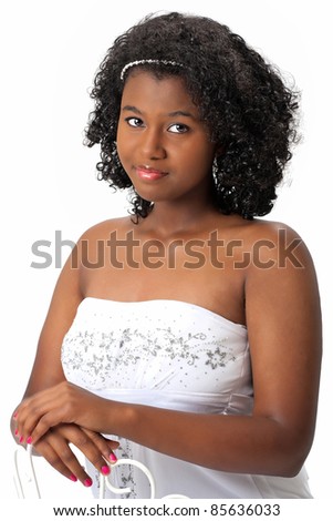 Beautiful African American Haitian teen girl wearing a white strapless top.  Photographed on a white background. Space for copy.
