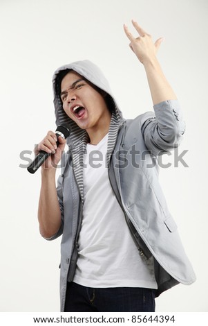 man holding microphone with the hand sign