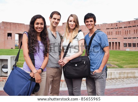 Fellow students posing outside a building