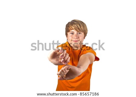portrait of cute boy with orange shirt gesturing with his arms