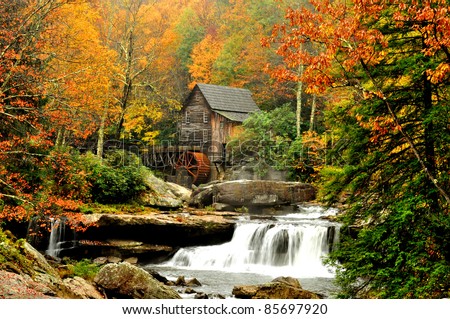Old grist mill in fall colors Royalty-Free Stock Photo #85697920