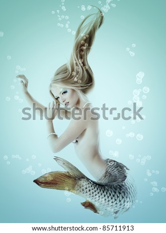 Portrait Of Beautiful Mermaid Girl With Fish Tail And Long Blond