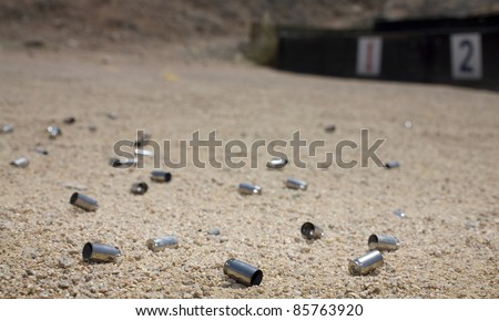 Empty ammo casings piling up near shooting lanes one and two Royalty-Free Stock Photo #85763920