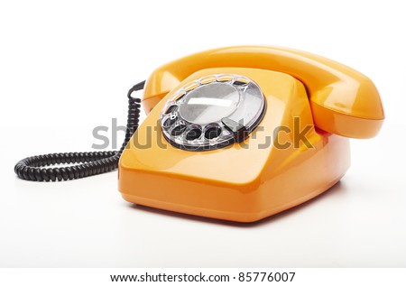 vintage orange telephone isolated over white background Royalty-Free Stock Photo #85776007