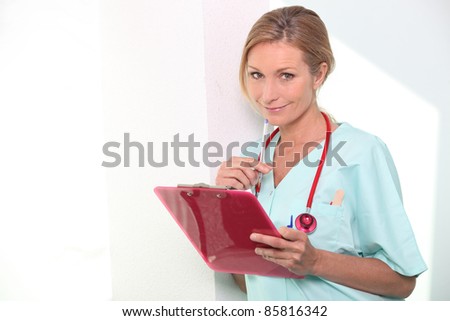 Nurse looking at notes
