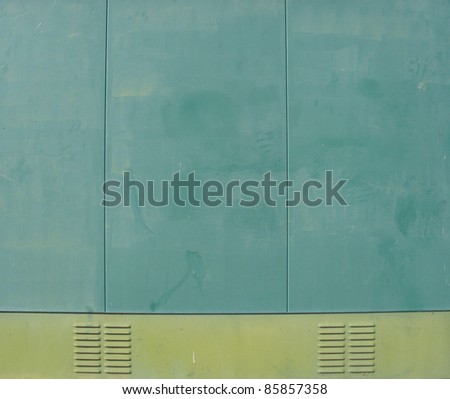 industrial cabin with green metal side panels and ventilation outlet