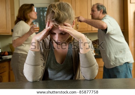 Teen daughter struggles while parents fight behind her Royalty-Free Stock Photo #85877758