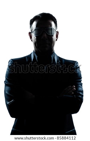 one caucasian man portrait silhouette serious arms crossed strange glasses in studio isolated white background