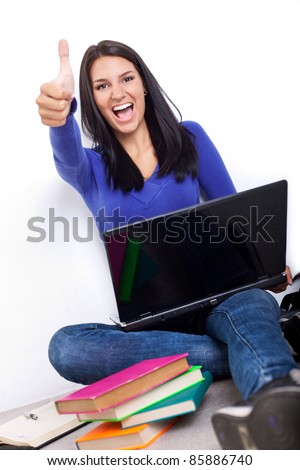 excited student girl  with laptop showing thumb up