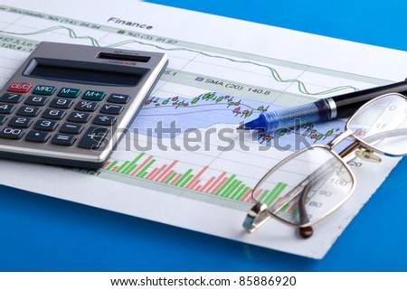 pen and calculator on stocks