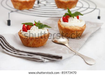 Cottage cheese cream tarts with a slices of strawberry
