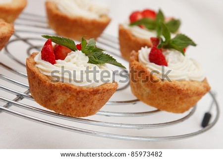 Cottage cheese cream tarts with a slices of strawberry