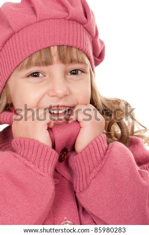 Portrait of a pretty little girl in sweater on white background