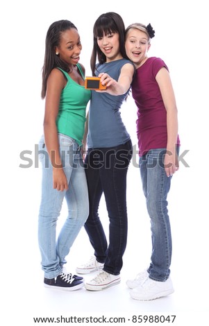 Fun photography with digital camera for three pretty young teenager girl friends a blonde caucasian, an oriental Japanese and an African American mixed race student all having a laugh together.