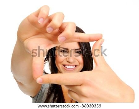 Attractive smiling woman using her hands to create a border around her face