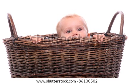 Funny picture of a hiding child in a basket. Birth metaphor.