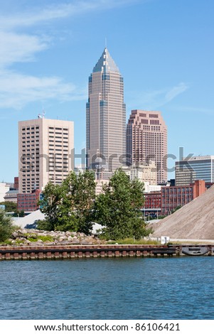 Skyscrapers:  A group of tall buildings that are part of the downtown financial district in Cleveland, Ohio with the Cuyahoga River in the foreground