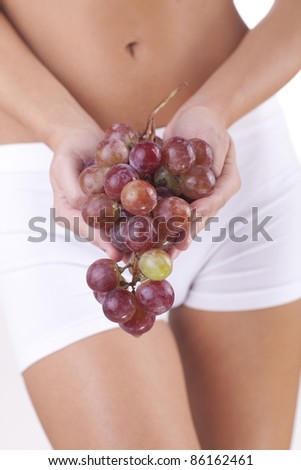 Female holding grapes.