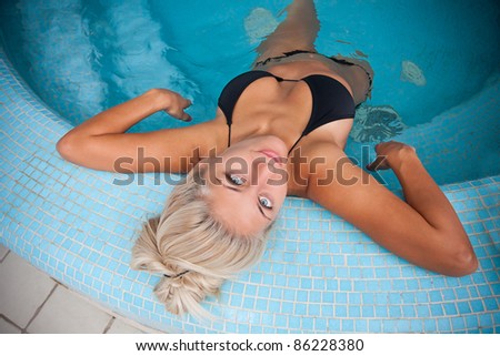 Beautiful young woman relaxing in jacuzzi