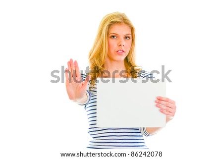 Beautiful teengirl holding blank paper sheet and showing stop gesture