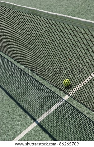 Tennis ball behind a net
