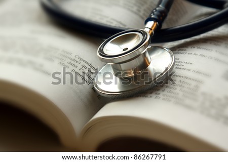 Stethoscope on open book isolated Royalty-Free Stock Photo #86267791