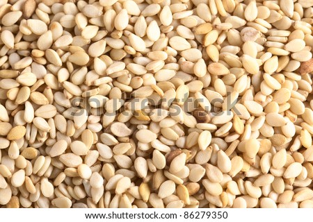 Raw sesame seeds as background (Selective Focus, Focus on the lower part of the picture)