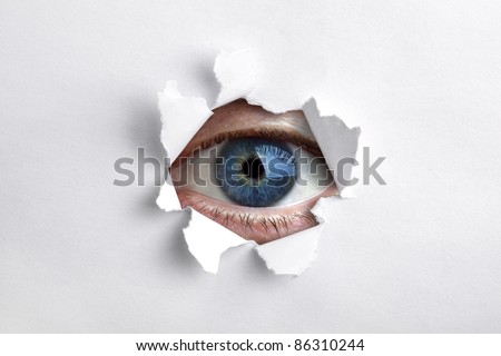 Mans eye peeking through a hole in white paper Royalty-Free Stock Photo #86310244