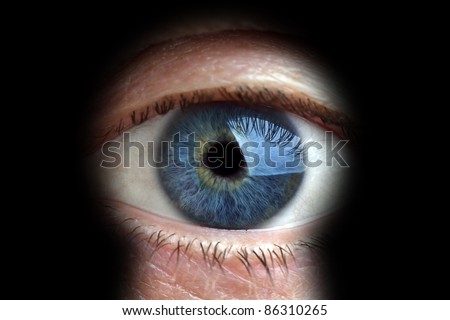 Mans eye looking through a blured keyhole Royalty-Free Stock Photo #86310265
