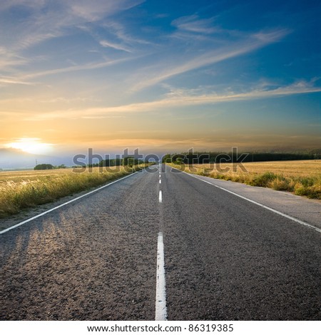 straight road and colorful sunset Royalty-Free Stock Photo #86319385