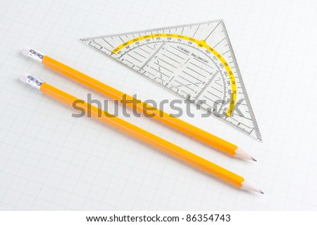Mathematics ruler and pencils on squared paper