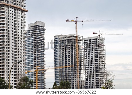 A Building cranes  and buildings  under construction