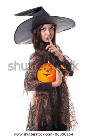 Photo of girl in halloween costume holding a pumpkin on the hand and making silence sign