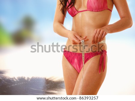 Unknown girl in bikini with tape-measure at  sea