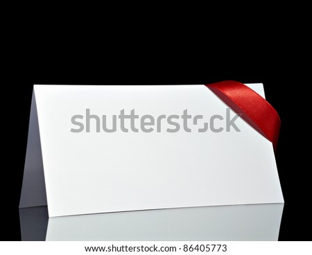 close up of  card note with  ribbon on black background