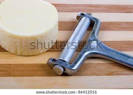 Round cheese on a wooden board