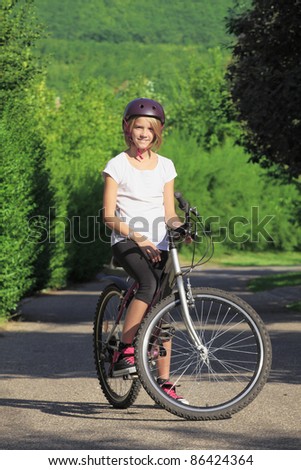 Young teenager girl mountain biking