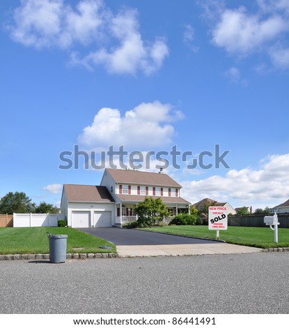 Real Estate For Sale Sold Sign on Landscaped Front Yard Lawn of Suburban Residential Neighborhood Home Sunny Blue Sky Cloudy Day