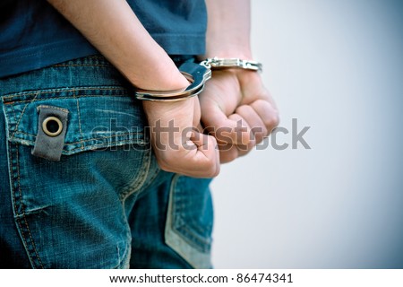 Young man in handcuffs Royalty-Free Stock Photo #86474341